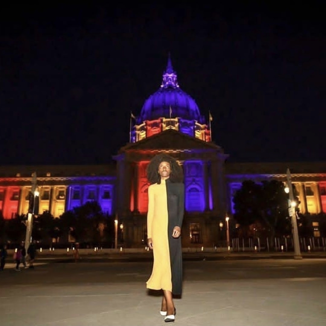 Evening portrait in front of illuminated building